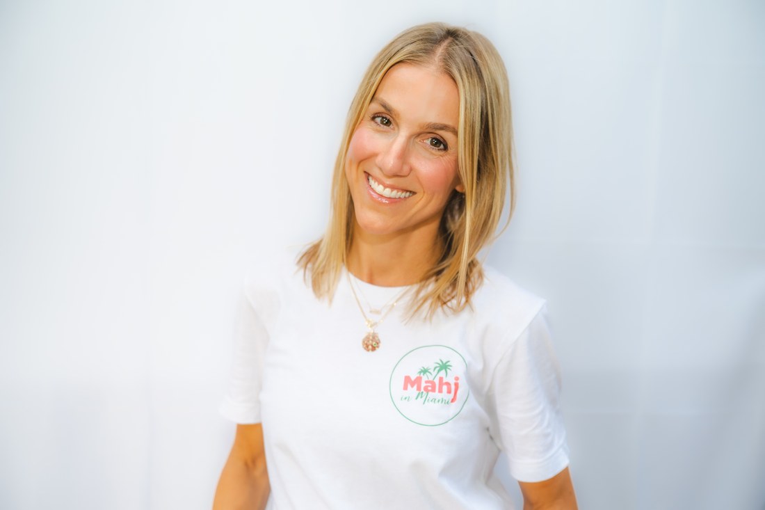 Abby, founder of Mahj in Miami, smiling in a Mahj in Miami tee